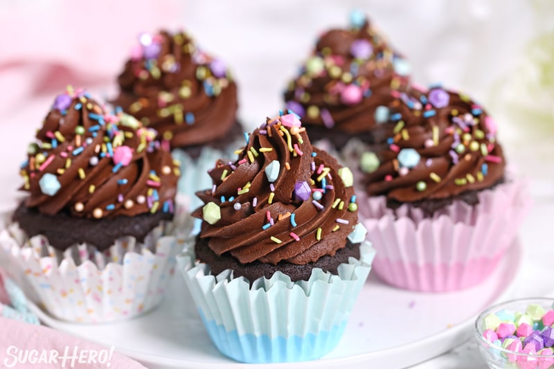 Group of chocolate cupcakes made from scratch, with chocolate frosting and sprinkles on top