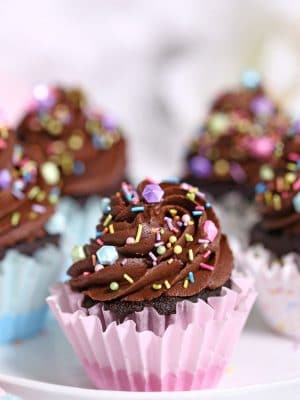 Close up of a Chocolate Cupcake with more cupcakes in the background.