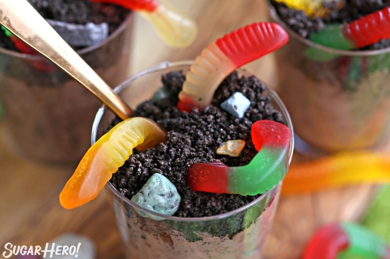 Overhead shot of a cup of dirt pudding, with a gold spoon handle sticking out the top.