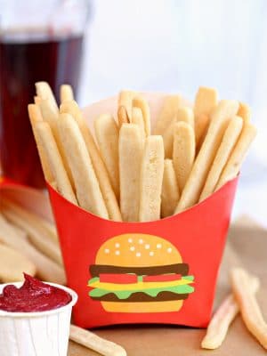 Sugar Cookie French Fries in red french fry container with frosting "ketchup" on the side.