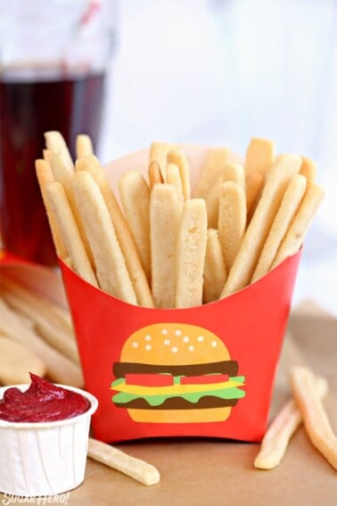 Sugar Cookie French Fries in red french fry container with frosting "ketchup" on the side.