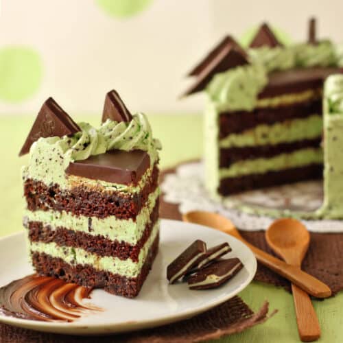 Slice of Mint Chocolate Chip Layer Cake on a white plate.