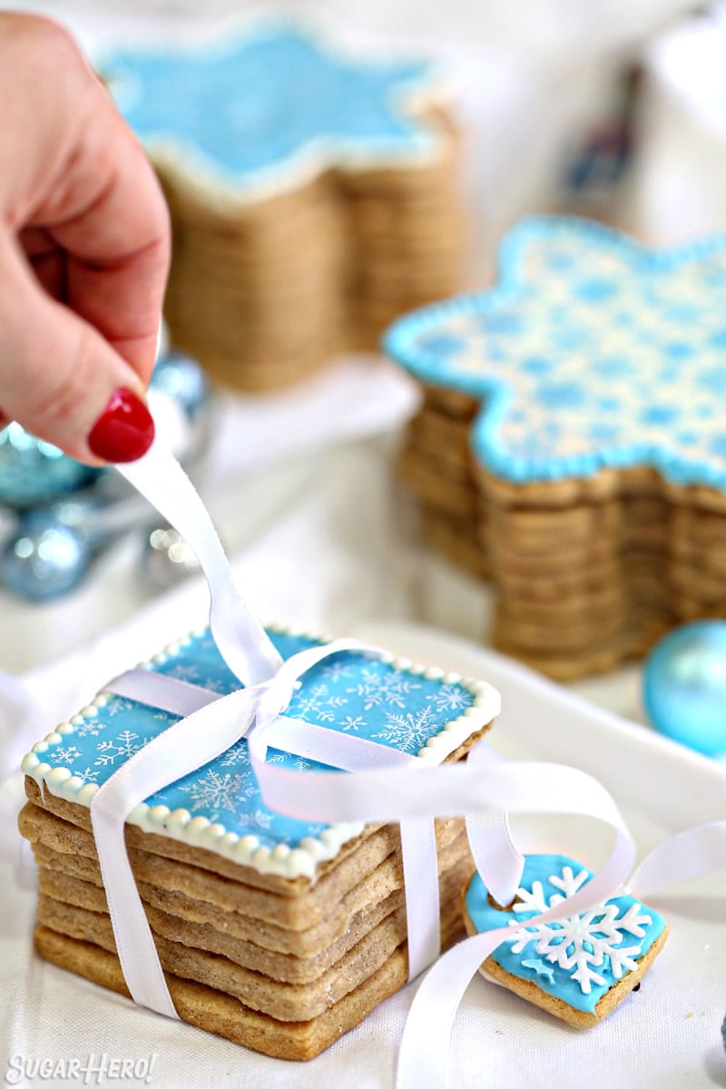 Blue Edible Christmas Cookie Box with white ribbon being wrapped around it