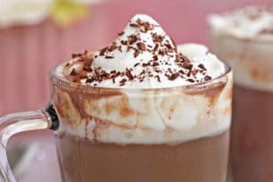 Slow Cooker Hot Chocolate topped with whipped cream, with text overlay for Pinterest