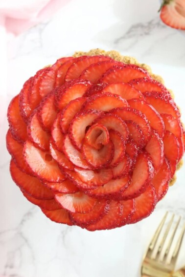 Overhead shot of Strawberry Rose Tart on a marble surface.