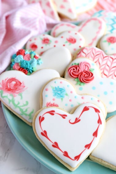 Blue plate of Valentine's Day sugar cookies decorated with royal icing.