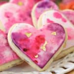 Close up of a Watercolor Rose Sugar Cookie on a white plate.