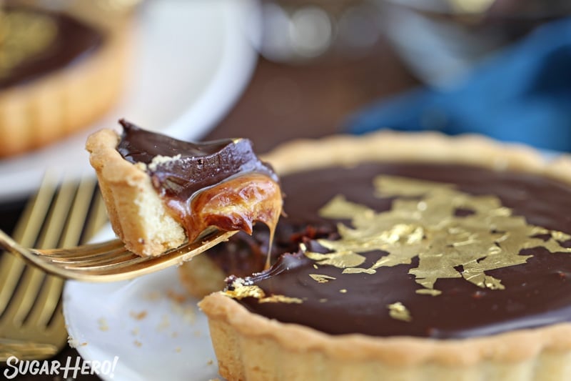 Close-up of fork taking a bite out of a Baileys Chocolate Caramel Tart