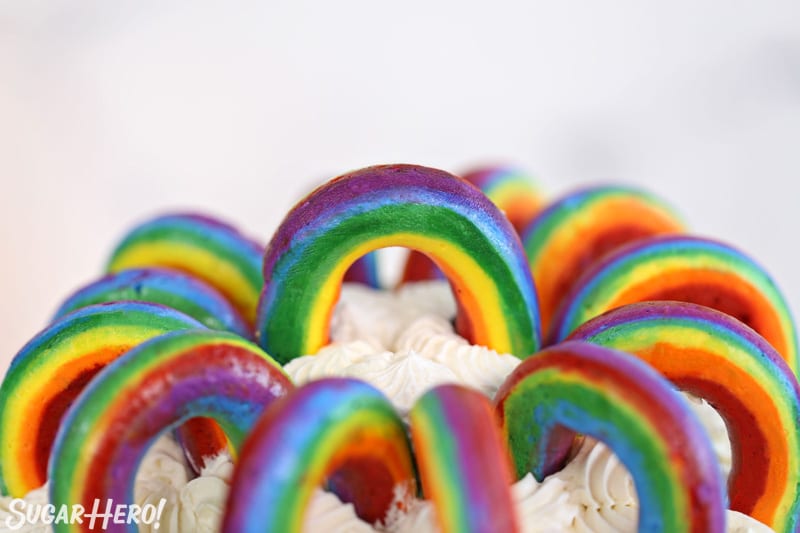 Close-up of Buttercream Rainbows on top of a white-frosted cake