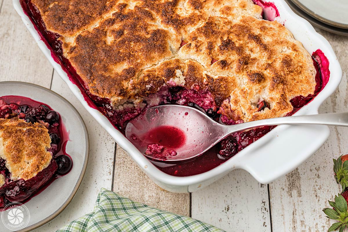 Dish of cooked berry cobbler with a portion scooped out