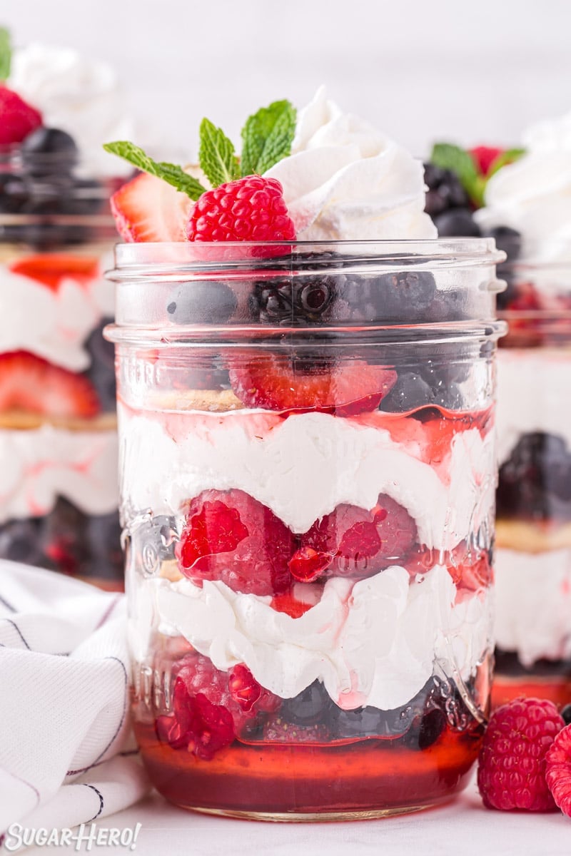 Close-up of Mixed Berry Shortcake in a mason jar with a mint sprig on top