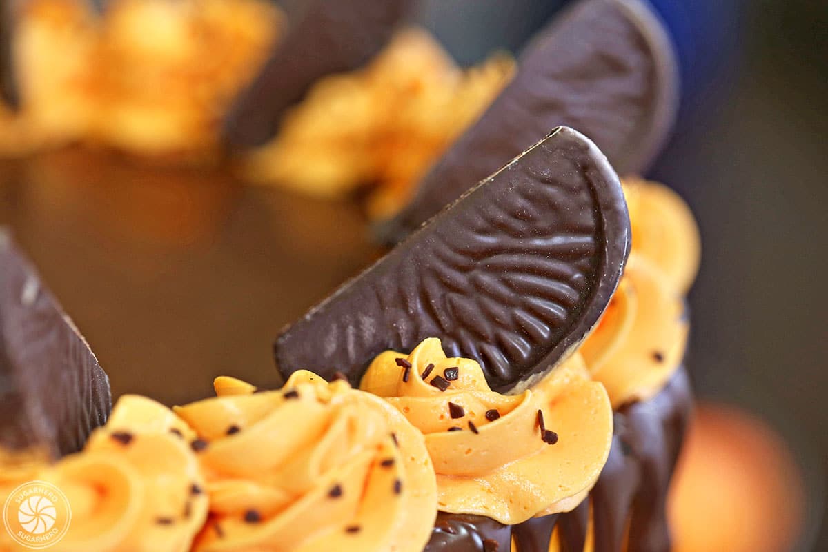 Close-up of chocolate orange slice on orange buttercream