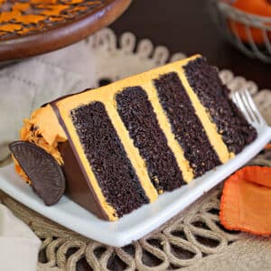 Slice of chocolate cake with orange buttercream between the layers.