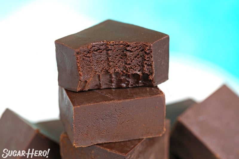 Stack of chocolate fudge with a bite taken out of the top piece