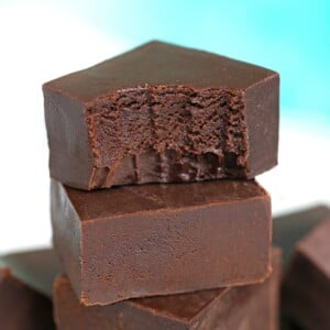 Stack of chocolate fudge with a bite taken out of the top piece.