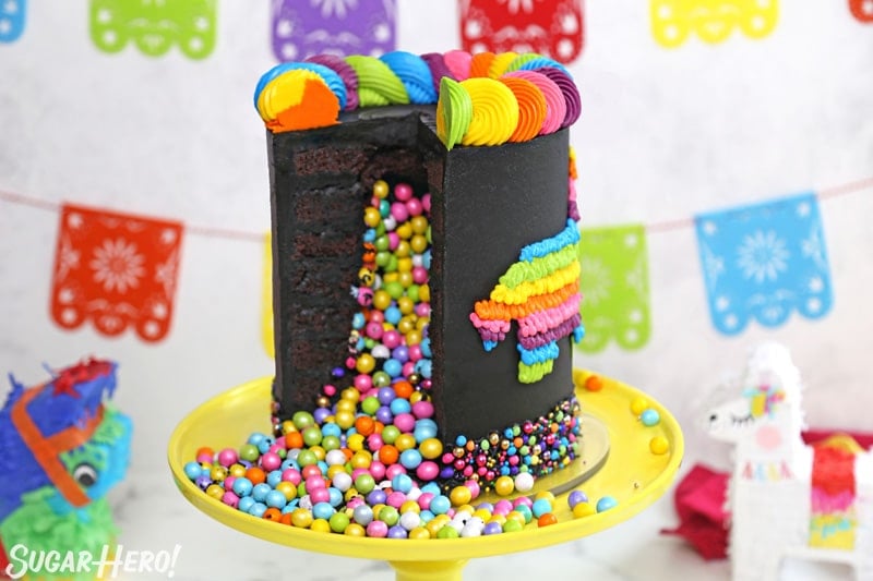 Chocolate pinata cake cut open, with colorful candy spilling out