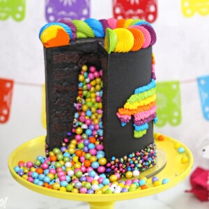Chocolate pinata cake cut open, with colorful candy spilling out