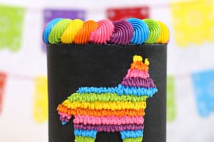 Picture of black and neon pinata cake with text overlay for Pinterest