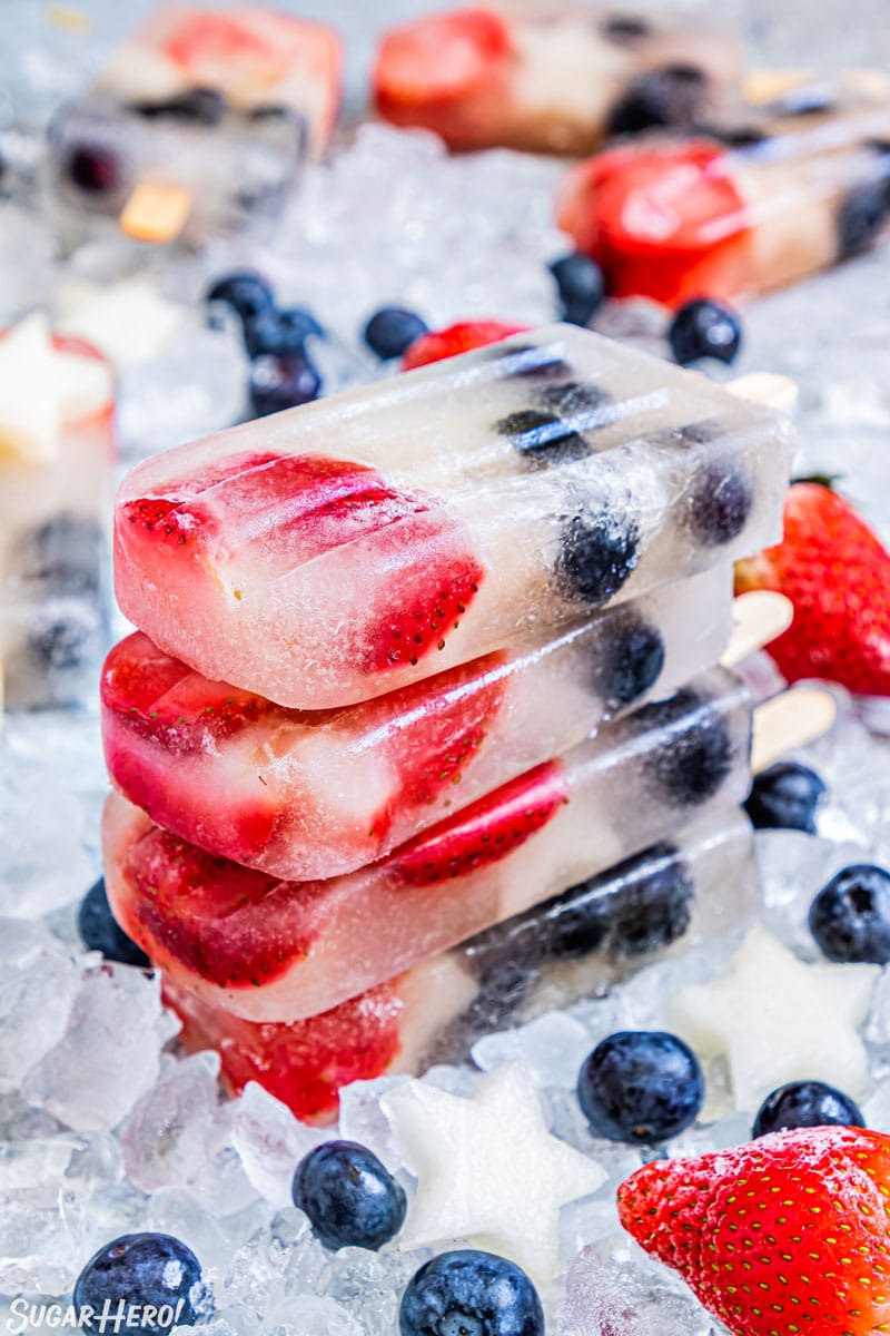 Stack of four Homemade Fruit Popsicles on a bed of ice