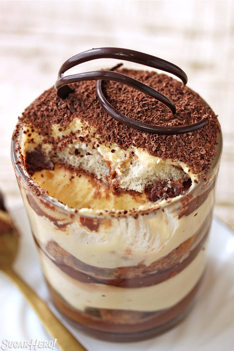 Cup of tiramisu with a bite taken out of it