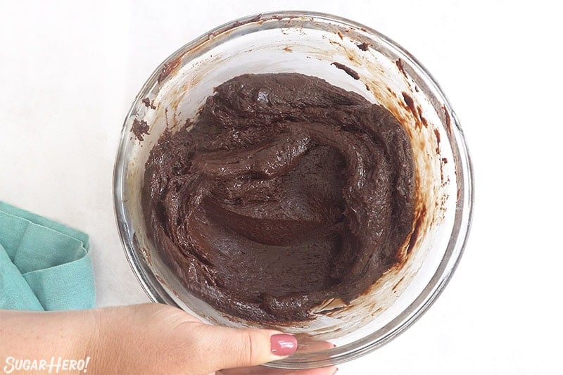 Glass bowl full of chocolate fudge with a broken texture.