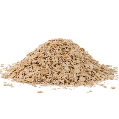 Rolled oats in a pile on a white surface.
