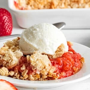 Close-up of Strawberry Crisp with a scoop of vanilla ice cream on top.