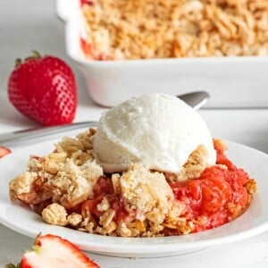 Close-up of Strawberry Crisp with a scoop of vanilla ice cream on top.
