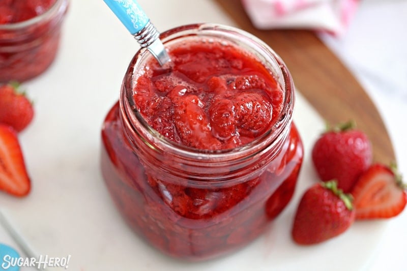 Overhead shot of Strawberry Sauce in a glass jar.