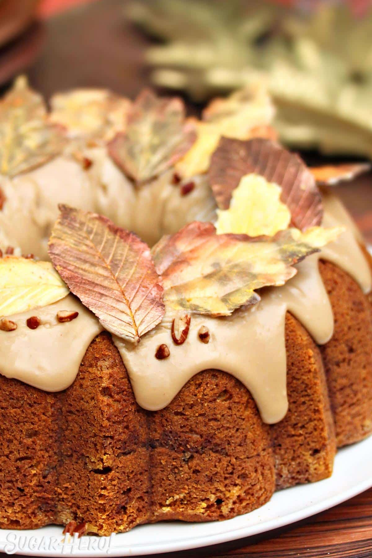 Golden chocolate leaves arranged around the edges of a bundt cake.