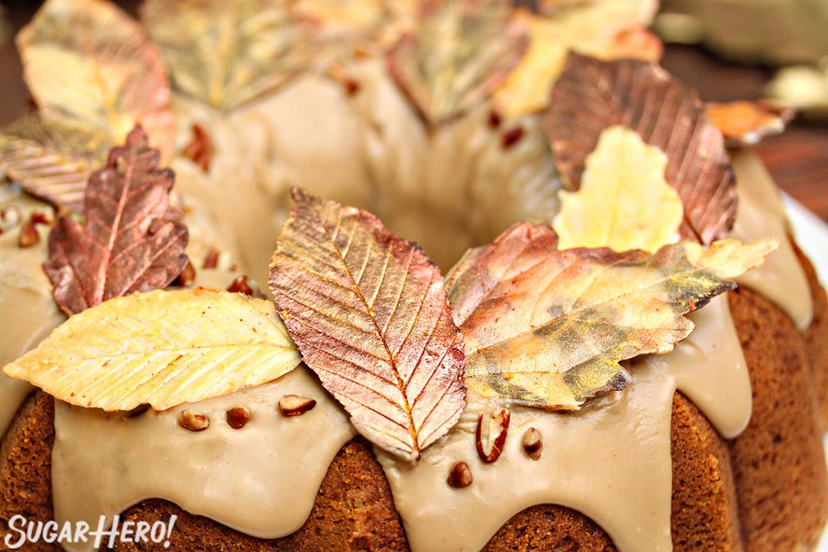 Golden chocolate leaves arranged around the edges of a bundt cake.