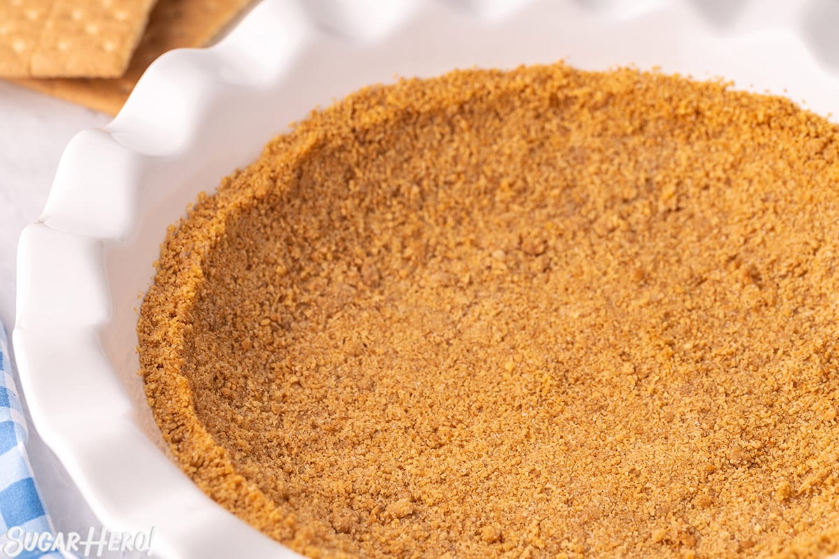 Photo of graham cracker crust in a white pie pan.