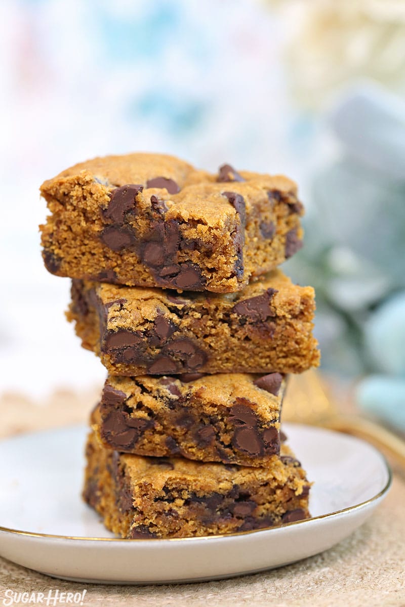 Stack of four Pumpkin Chocolate Chip Bars on a white plate.