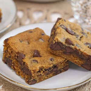 Close-up of two Pumpkin Chocolate Chip Bars on a white plate.