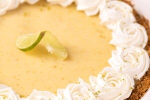 A whole key lime pie with the words "Key Lime Pie" overlaid in the top left corner.