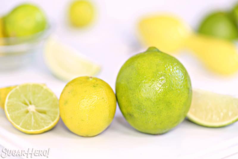A close up photo of a keylime and a persian lime side by side.
