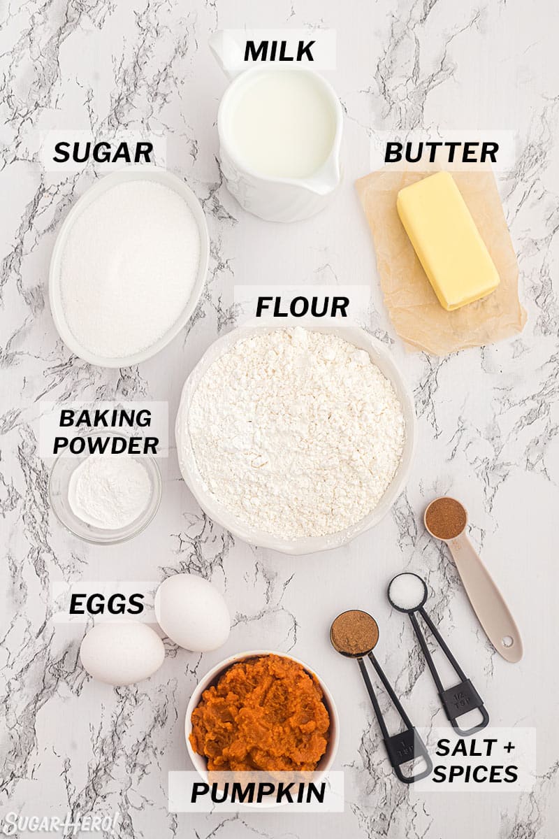 Photo of various ingredients for pumpkin spice cupcakes measured out on a marble counter.