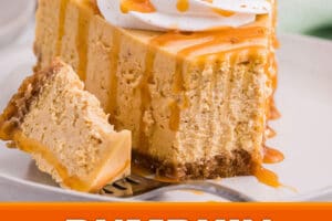 Slice of pumpkin spice cheesecake topped with whipped cream and caramel sauce with a bite missing from the slice and set next to it on a white plate.