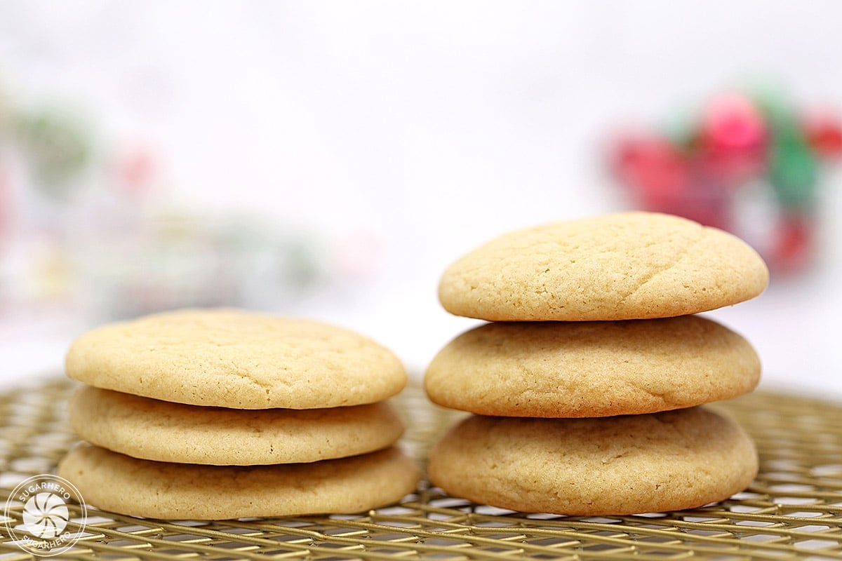 Comparison of 3 flat sugar cookies in a stack next to three puffy sugar cookies in a stack.