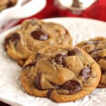 Three Gingerbread Chocolate Chip Cookies on an embossed white plate.