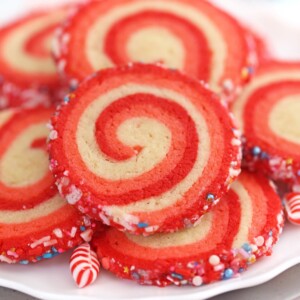 Close-up of baked Peppermint Pinwheel Cookies on white plate.