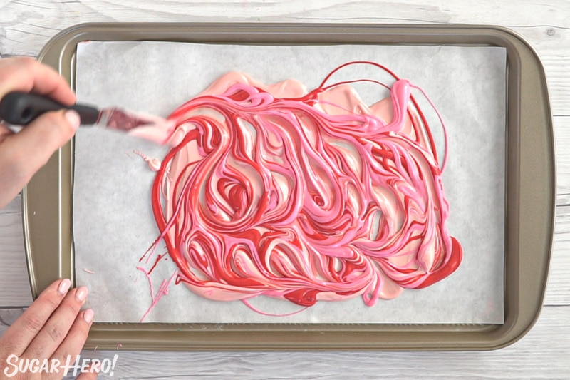 Swirling red and pink candy melts together to make swirled bark.