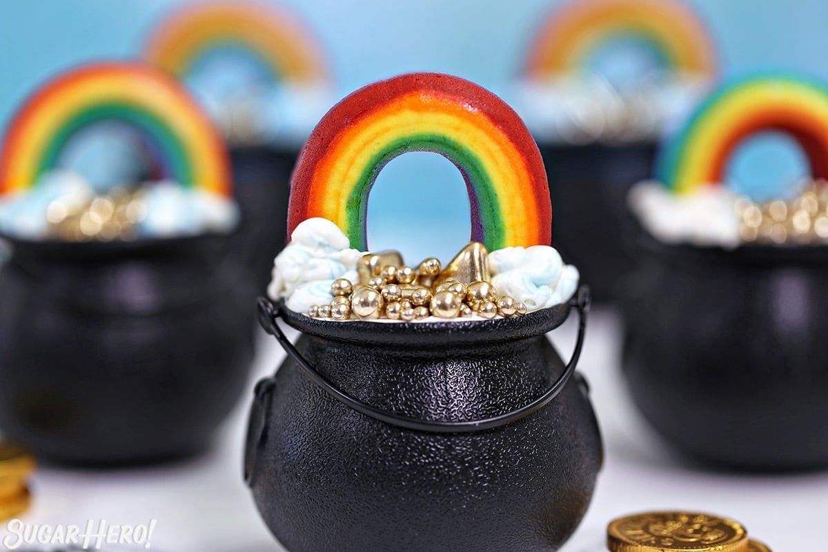 Close-up of a group of Pot of Gold Cupcakes with gold coins scattered around.