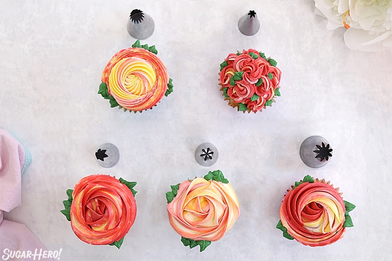 Overhead shot of 5 different rosette cupcakes along with the piping tips used to make them.