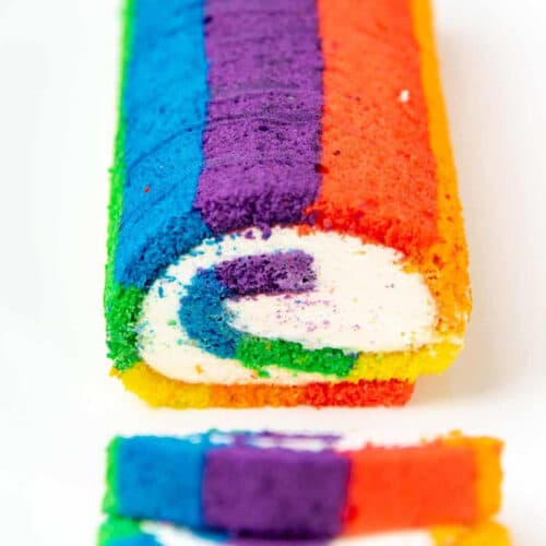 Rainbow striped swiss cake roll cut open.