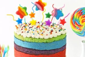 Photo of Rainbow Mousse Cake with text overlay for Pinterest.