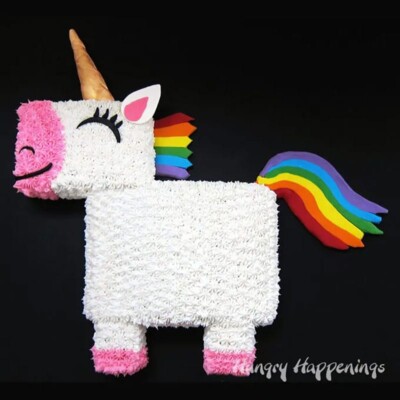 Cute unicorn cake frosted with buttercream with a rainbow tail and mane.