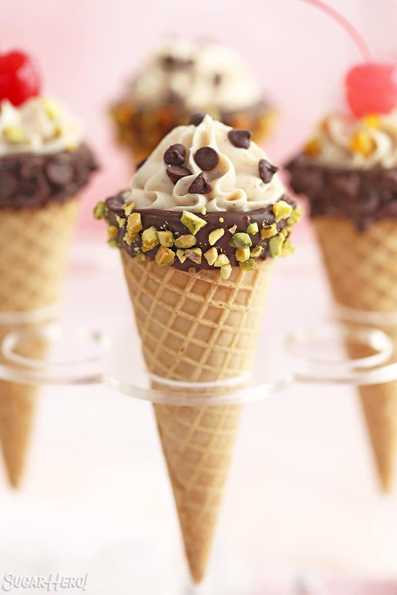 Cannoli cone with edge dipped in pistachios and mini chocolate chips on top.