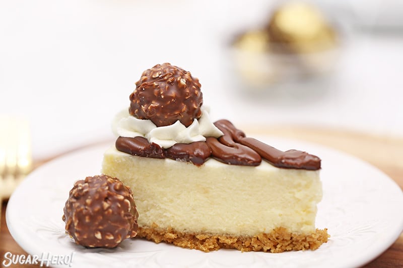 Slice of cheesecake with Nutella and Ferrero Rocher candies on top.