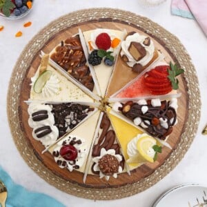 Overhead shot of a cheesecake sampler showing 10 different flavors of cheesecake.